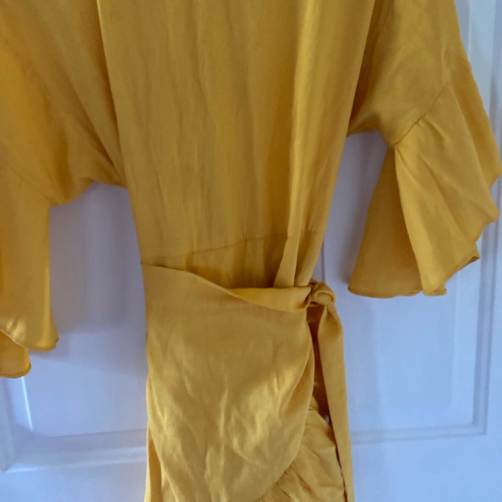 Women summer yellow dress with wrapping skirt round the waist .